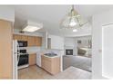 Bright kitchen with updated appliances, ample cabinet space, and a view of the living area at 5265 Caspian Springs Dr # 201, Las Vegas, NV 89120