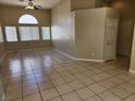 Open floor plan with neutral color palette, tile floors, and high vaulted ceiling at 5605 Midnight Breeze St, North Las Vegas, NV 89081