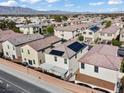 An aerial view showing solar panels on the roof of homes in a residential area at 5667 Foxglove Field St, Las Vegas, NV 89130