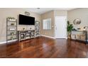Inviting living room with beautiful hardwood floors, stylish décor, and ample natural light at 5967 Aimless St, Henderson, NV 89011