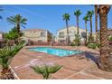 Relaxing community pool surrounded by palm trees and well-maintained landscaping at 6170 E Sahara Ave # 1076, Las Vegas, NV 89142