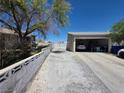 Long driveway leading to a detached garage with block wall at 7108 Moon Ct, Las Vegas, NV 89145