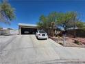 Single story home with a long driveway and desert landscaping at 7108 Moon Ct, Las Vegas, NV 89145