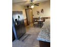 Bright eat-in kitchen with tile floors and stainless steel refrigerator at 712 Donner St, Las Vegas, NV 89107