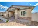 Charming front porch with stone columns and desert landscaping enhance the curb appeal of this home at 794 Sunny Sagebrush St, Henderson, NV 89011