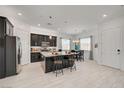 Bright kitchen with stainless steel appliances, granite countertops, and a breakfast bar at 794 Sunny Sagebrush St, Henderson, NV 89011