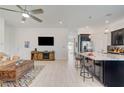 Open-concept living room and kitchen boasts modern appliances, tile floors, and a spacious layout at 794 Sunny Sagebrush St, Henderson, NV 89011