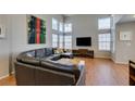 Spacious living room featuring high ceilings, large windows, and comfortable sectional seating at 8021 Hilliard Ave, Las Vegas, NV 89128