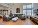 Bright living room boasts soaring ceilings, large windows, and a comfortable sectional sofa at 8021 Hilliard Ave, Las Vegas, NV 89128