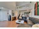 Open concept living area with high ceilings, hardwood floors, and a cozy sectional sofa at 8021 Hilliard Ave, Las Vegas, NV 89128