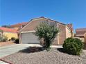 Single-Gathering home with a two-car garage, drought-resistant landscaping, and a classic tile roof at 8900 Big Bear Pines Ave, Las Vegas, NV 89143