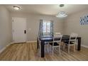 Modern dining room featuring a dark wood table and chairs, with ample lighting at 920 Biltmore Dr, Las Vegas, NV 89101