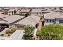 Beautiful aerial view of a single-story home with desert landscaping, a two-car garage, and a well-maintained yard at 9288 Valley Betica Ave, Las Vegas, NV 89148