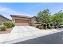 Charming home featuring a two-car garage and desert landscaping, complemented by a concrete driveway at 9288 Valley Betica Ave, Las Vegas, NV 89148