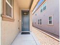 Inviting blue front door with decorative glass and neutral-colored exterior, enhancing curb appeal and modern style at 9288 Valley Betica Ave, Las Vegas, NV 89148