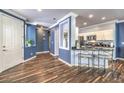 Inviting entryway with white door, hardwood floors, and open access to the kitchen at 979 Coatbridge St, Las Vegas, NV 89145