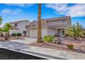 Beautiful front of the home with desert landscaping and a two-car garage, with a blue sky at 1068 African Eagle Ave, Henderson, NV 89015