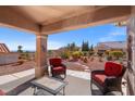 Inviting covered patio with comfortable seating, perfect for relaxing and enjoying scenic backyard views at 10921 Grand Haven Ave, Las Vegas, NV 89134