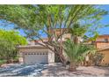 Lovely two-story home with mature landscaping and a spacious driveway, showcasing its curb appeal at 11074 Caramel Crest Ct, Las Vegas, NV 89135