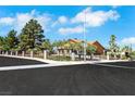 Beautiful home featuring a well-maintained yard, secure wrought iron fence, and a tranquil residential street at 1385 Morning Sun Way, Las Vegas, NV 89110