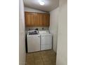 Convenient laundry room featuring tile flooring and a modern washer and dryer set at 237 Piute Ln, Henderson, NV 89015