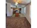 Spacious living room featuring plush carpeting, natural light, and an open layout at 237 Piute Ln, Henderson, NV 89015