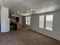 Open-concept living space boasting neutral walls, abundant windows, and a ceiling fan at 237 Piute Ln, Henderson, NV 89015