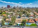Panoramic aerial view of a residential neighborhood, showcasing lush landscaping, swimming pools, and the city skyline at 2504 La Solana Way, Las Vegas, NV 89102