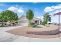 Charming single-story home with desert landscaping, a two-car garage, and a well-maintained lawn at 2504 Libretto Ave, Henderson, NV 89052