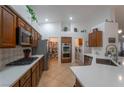 Modern kitchen featuring stainless steel appliances, quartz countertops, and a convenient pantry at 2640 Torch Ave, North Las Vegas, NV 89081