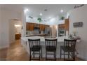 Bright kitchen features wood cabinets, modern appliances, and a spacious center island with bar stool seating at 2640 Torch Ave, North Las Vegas, NV 89081