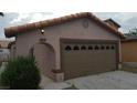 Tan single-Gathering home with an attached two-car garage and decorative windows at 2777 Beaconfalls Way, Las Vegas, NV 89142