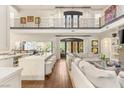 Open concept living room featuring a soaring ceiling, white sofas, a gourmet kitchen, and seamless indoor-outdoor flow at 2793 Red Arrow Dr, Las Vegas, NV 89135