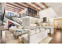 Spacious living room with soaring ceilings, wooden beams, grand staircase, and gourmet kitchen creates an inviting atmosphere at 2793 Red Arrow Dr, Las Vegas, NV 89135