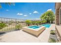 Inviting pool and hot tub featuring a stone surround and well-manicured landscaping at 3042 Soft Horizon Way, Las Vegas, NV 89135