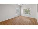 Bright bedroom with wood floors and large window overlooking the backyard at 3580 S Shawnee Ave, Pahrump, NV 89048