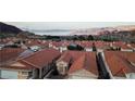 Residential community with homes with tile roofs, well-manicured landscaping, mountain views, and mature shade trees at 390 Montego Ln, Boulder City, NV 89005