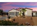 Charming single-story home boasts a two-car garage and a desert-style front yard with palm trees at 4620 E Suntree Ct, Pahrump, NV 89061
