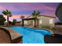 Inviting backyard showcasing a sparkling blue pool and a covered patio, perfect for outdoor relaxation at 4620 E Suntree Ct, Pahrump, NV 89061