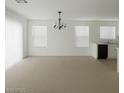 Bright and airy living room area with neutral walls, carpet, and a chandelier at 520 Shire Hall St, Las Vegas, NV 89178