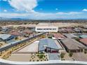 An aerial view of a residential home in an expansive neighborhood with mountain views and clear blue skies at 5264 Mystic Ivy Dr, Las Vegas, NV 89149