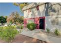 Close-up of the townhome entrance highlighting the door, address, and manicured bushes at 565 Greenbriar Townhouse Way, Las Vegas, NV 89121