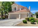 Charming home with a three-car garage, well-maintained landscaping, and a beautiful terracotta roof at 5908 Marbrisas Ln, Las Vegas, NV 89130
