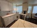 Bright kitchen featuring white cabinets, stainless steel appliances, and modern countertops at 5908 Marbrisas Ln, Las Vegas, NV 89130