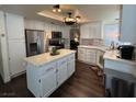 Bright kitchen with stainless steel appliances, white cabinets, and large center island at 5908 Marbrisas Ln, Las Vegas, NV 89130