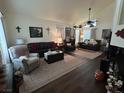 Inviting living room featuring dark wood floors, neutral walls, and comfortable seating arrangement at 5908 Marbrisas Ln, Las Vegas, NV 89130