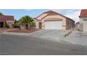 Charming single-story home with a tile roof, two-car garage, desert landscaping, and covered front porch at 6138 Crystal Flower Way, North Las Vegas, NV 89031
