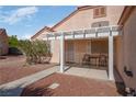Cozy front patio with pergola cover, seating, and desert landscaping, perfect for enjoying the outdoors at 6138 Crystal Flower Way, North Las Vegas, NV 89031