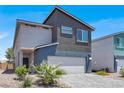 Modern two-story home featuring a two-car garage, neutral color palette and low maintenance landscaping at 66 Chelsea Manor Ct, Las Vegas, NV 89110