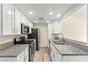 Well-lit kitchen featuring modern appliances, granite countertops, and ample cabinet space for efficient meal preparation at 727 Heritage Vista Ave, Henderson, NV 89015